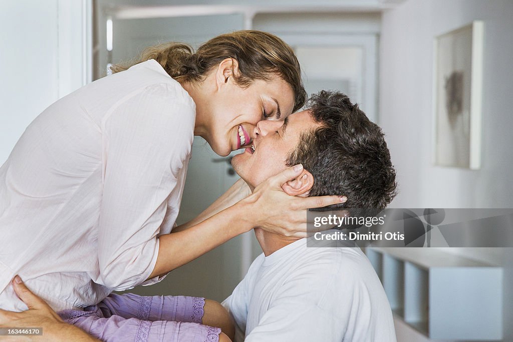 Couple smiling and about to kiss passionately