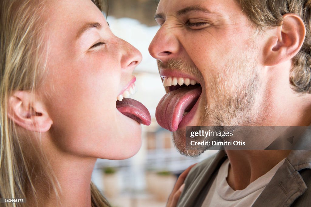 Young couple nervous to touch tongues