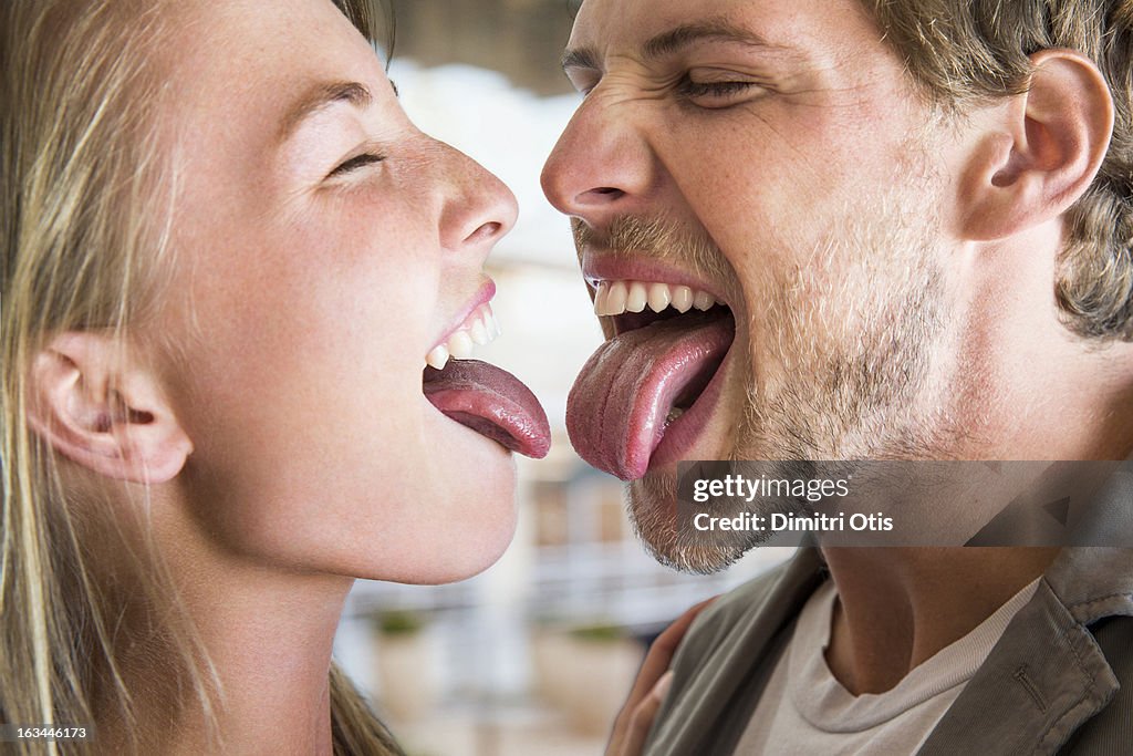 Young couple nervous to touch tongues