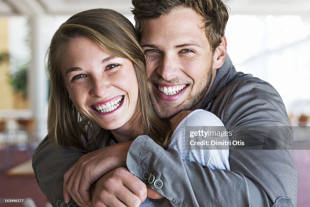 Young man tightly embracing his girlfriend