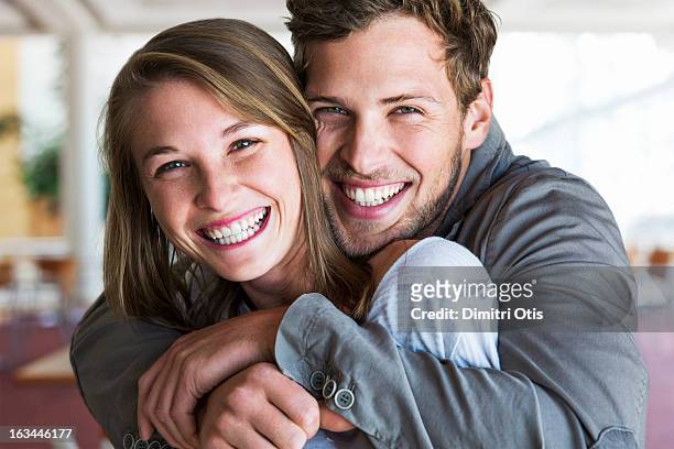 young man tightly embracing his girlfriend - guancia a guancia foto e immagini stock