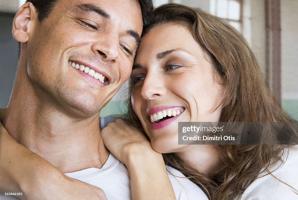 Smiling couple touching heads romantically
