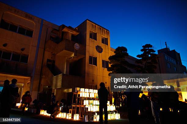 Students and volunteers gather and light candles at Yuriage Junior Hight School during a ceremony prior to the second anniversary commemoration of...