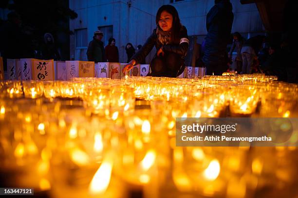 Students and volunteers gather and light candles at Yuriage Junior Hight School during a ceremony prior to the second anniversary commemoration of...