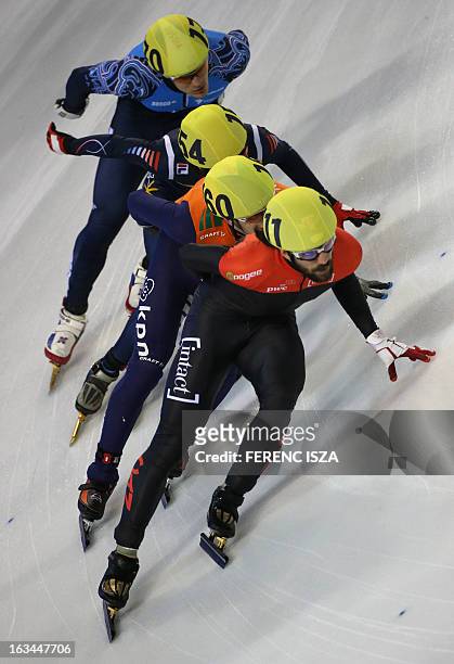 Charles Hamelin of Canada, Sjinkie Knegt of the Netherlands, Kim Yun-Jae of Korea and Vladimir Grigorev of Russia compete in men's 1000m quarter...