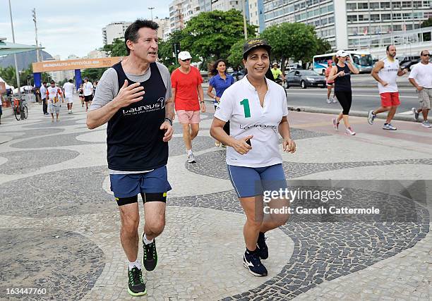 Laureus Academy Members Lord Sebastian Coe and Nawal El Moutawakel in action during the Laureus Run Copacabana Beach on March 10, 2013 in Rio de...