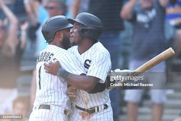 Tim Anderson of the Chicago White Sox celebrates with Elvis Andrus after scoring the game winning run on a throwing by the Seattle Mariners during...