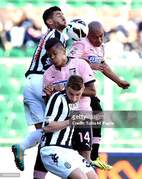 Alessio Sestu and Matteo Rubin of Siena and Arevalo Rios ans Anselmo De Moraes of Palermo compete for a heades during the Serie A match between US...