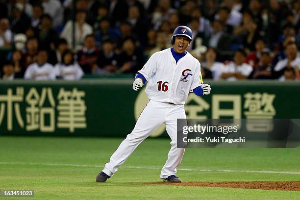 Szu-Chi Chou of Team Chinese Taipei reacts to hitting a RBI single in the bottom of the eighth inning during Pool 1, Game 2 between Japan and Chinese...