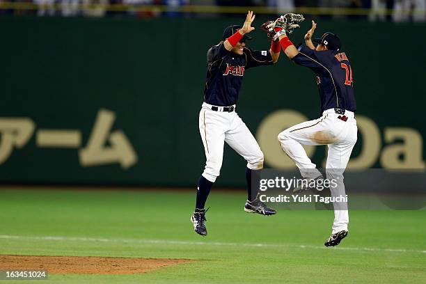 Seiichi Uchikawa and Yoshio Itoi of Team Japan celebrate defeating Team Chinese Taipei in extra innings in Pool 1, Game 2 in the second round of the...