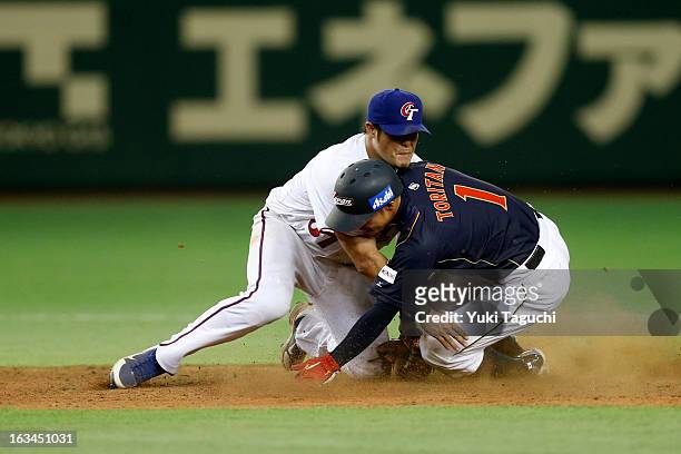 Takashi Toritani of Team Japan steals second base in the top of the ninth inning as Chih-Sheng Lin of Team Chinese Taipei applies the tag during Pool...