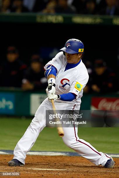 Szu-Chi Chou of Team Chinese Taipei hits a RBI single in the bottom of the eighth inning during Pool 1, Game 2 between Japan and Chinese Taipei in...