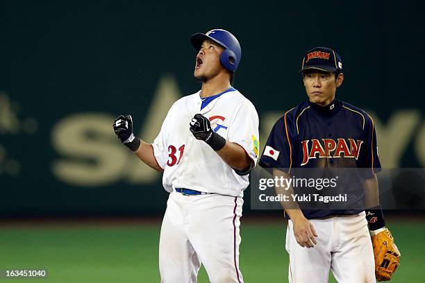 Chih-Sheng Lin of Team Chinese Taipei reacts to hitting a double in the bottom of the eighth inning during Pool 1, Game 2 between Japan and Chinese...