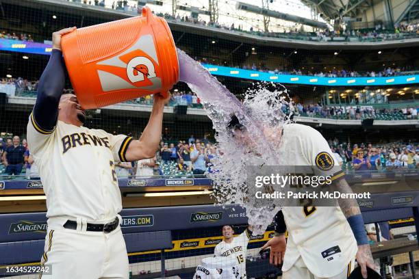 Willy Adames of the Milwaukee Brewers pours Gatorade on Brice Turang after he hit a walk-off RBI single in the 10th inning against the Minnesota...