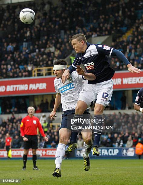 Blackburn Rover's English defender Scott Dann vies with Millwall's Australian defender Shane Lowry during the English FA Cup quarter-final football...