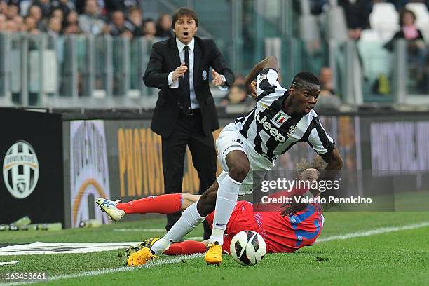 Paul Pogba of FC Juventus runs of Giovanni Marchese of Calcio Catania during the Serie A match between FC Juventus and Calcio Catania at Juventus...