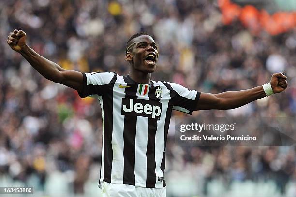 Paul Pogba of FC Juventus celebrates the goal of his team-mates Emanuele Giaccherini during the Serie A match between FC Juventus and Calcio Catania...