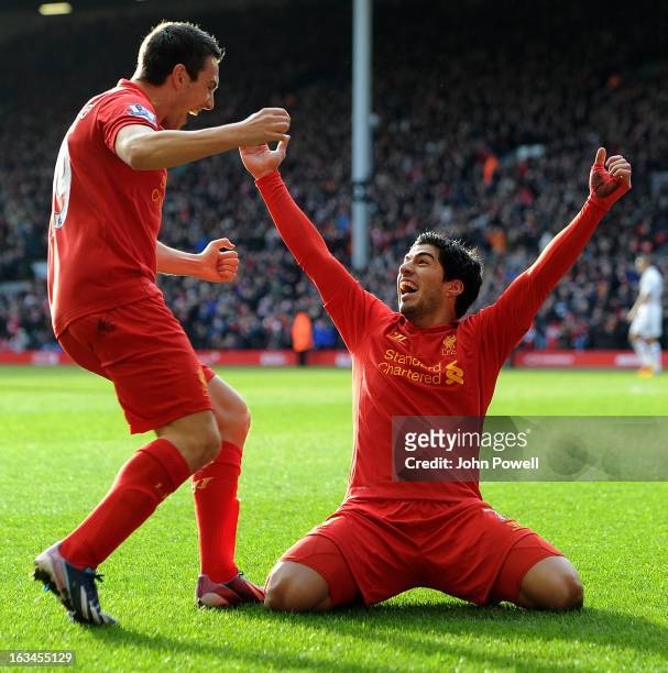 Luis Suarez of Liverpool celebrates with team-mate Stewart Downing after scoring a goal during the Barclays Premier League match between Liverpool...