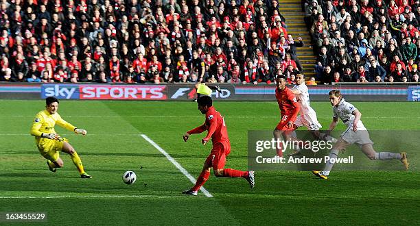 Luis Suarez of Liverpool scores the first goal to make it 1-0 during the Barclays Premier League match between Liverpool and Tottenham Hotspur at...