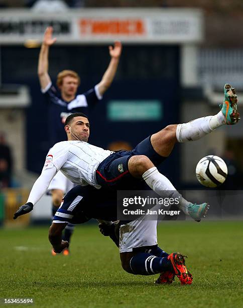 Leon Best of Blackburn Rovers loses his footing under pressure from Danny Shittu of Millwall during the FA Cup sponsored by Budweiser sixth round...