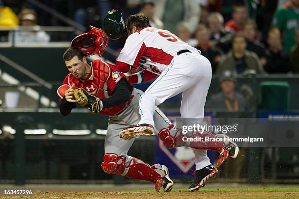 Karim Garcia of Mexico collides with Chris Robinson of Canada at home plate during the World Baseball Classic First Round Group D game on March 9,...