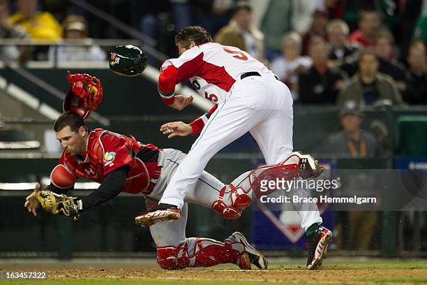 Karim Garcia of Mexico collides with Chris Robinson of Canada at home plate during the World Baseball Classic First Round Group D game on March 9,...