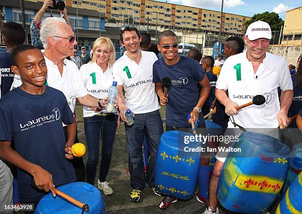 Laureus Academy Member Franz Beckenbauer with Laureus Ambassadors Michael Teuber and Axel Schulz attend the Mercedes-Benz Sprinter handover to the...