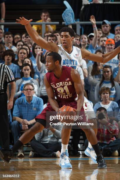 Michael Snaer of the Florida State Seminoles passes the ball under pressure from Michael Snaer of the Florida State Seminoles on March 03, 2013 at...