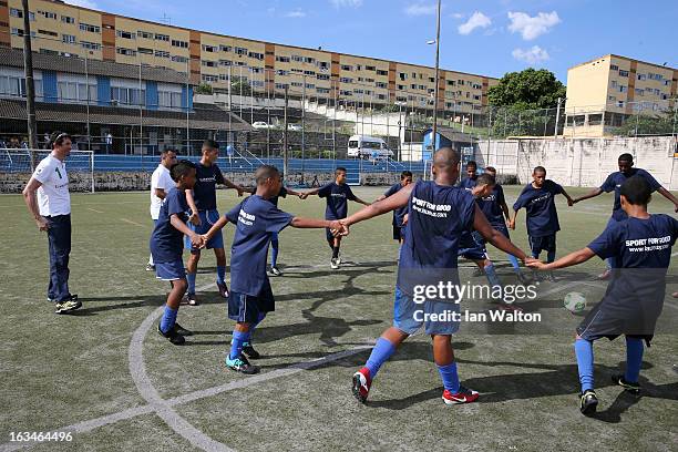 Local children play football at the Mercedes-Benz Sprinter handover to the Bola Project during 2013 Laureus World Sports Awards on March 10, 2013 in...