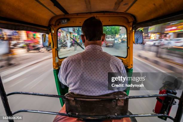 indian man drives auto rickshaw (tuk-tuk), india - rickshaw driver stock pictures, royalty-free photos & images