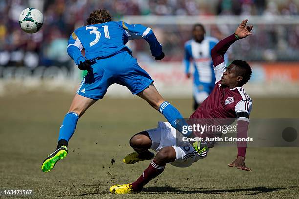 Deshorn Brown of the Colorado Rapids collides with Jeff Parke of the Philadelphia Union during the second half at Dick's Sporting Goods Park on March...