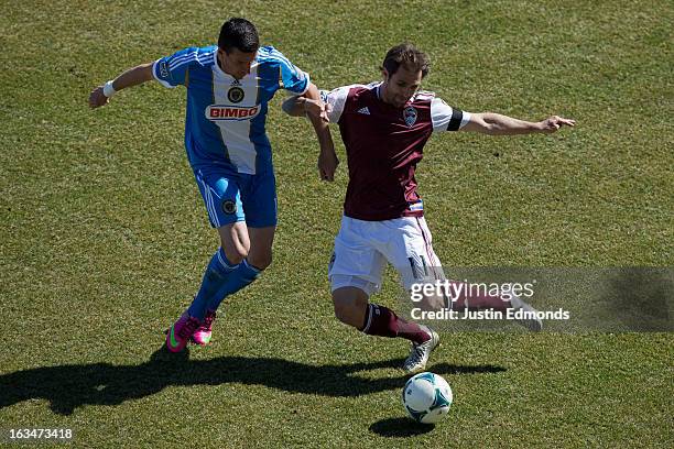 Brian Mullan of the Colorado Rapids battles for the ball with Sebastien Le Toux of the Philadelphia Union during the first half at Dick's Sporting...