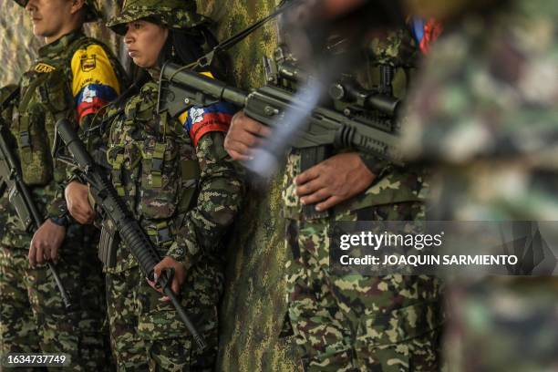 Guerrilla fighters from the FARC dissidence Jaime Martinez stand guard as commander Andrey gives an interview near the town of Suarez, department of...