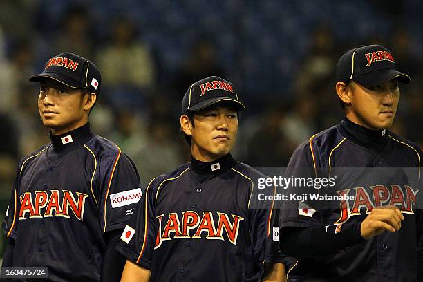 Infielder Takashi Toritani and Infielder Hirokazu Ibata and Outfielder Seiichi Uchikawa of Japan look on during the World Baseball Classic Second...