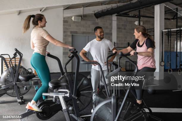 a group of people are training on exercise bikes. - gym 81 stock pictures, royalty-free photos & images