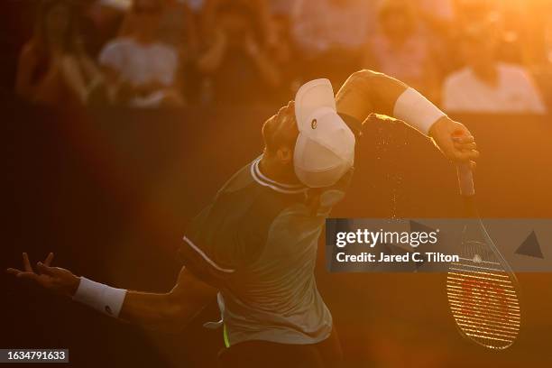 Borna Coric of Croatia serves to Michael Mmoh of the United States during their third round match of the Winston-Salem Open at Wake Forest Tennis...