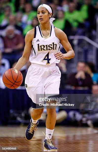 Skylar Diggins of the Notre Dame Fighting Irish dribbles the ball up court against the Connecticut Huskies at Purcel Pavilion on March 4, 2013 in...