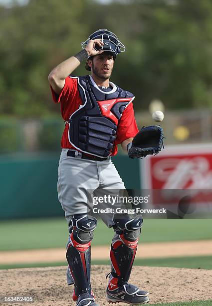 Arencibia of Team USA visits the pitchers mound in a game against the Chicago White Sox during a WBC exhibition action at Camelback Ranch on March 5,...