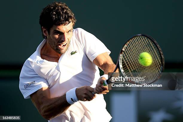 Pablo Andujar of Spain returns a shot to Tommy Haas of Germany during the BNP Paribas Open at the Indian Wells Tennis Garden on March 10, 2013 in...