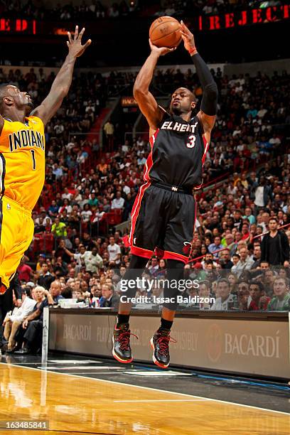 Dwyane Wade of the Miami Heat shoots a three-pointer against Lance Stephenson of the Indiana Pacers on March 10, 2013 at American Airlines Arena in...