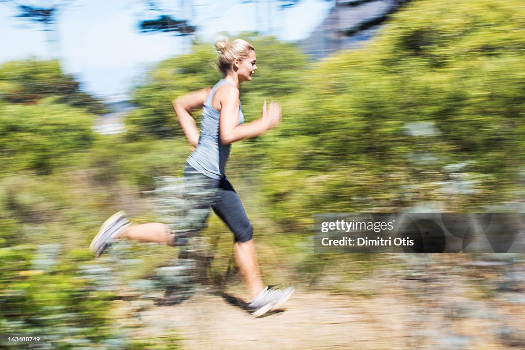 Young woman running with motion blur