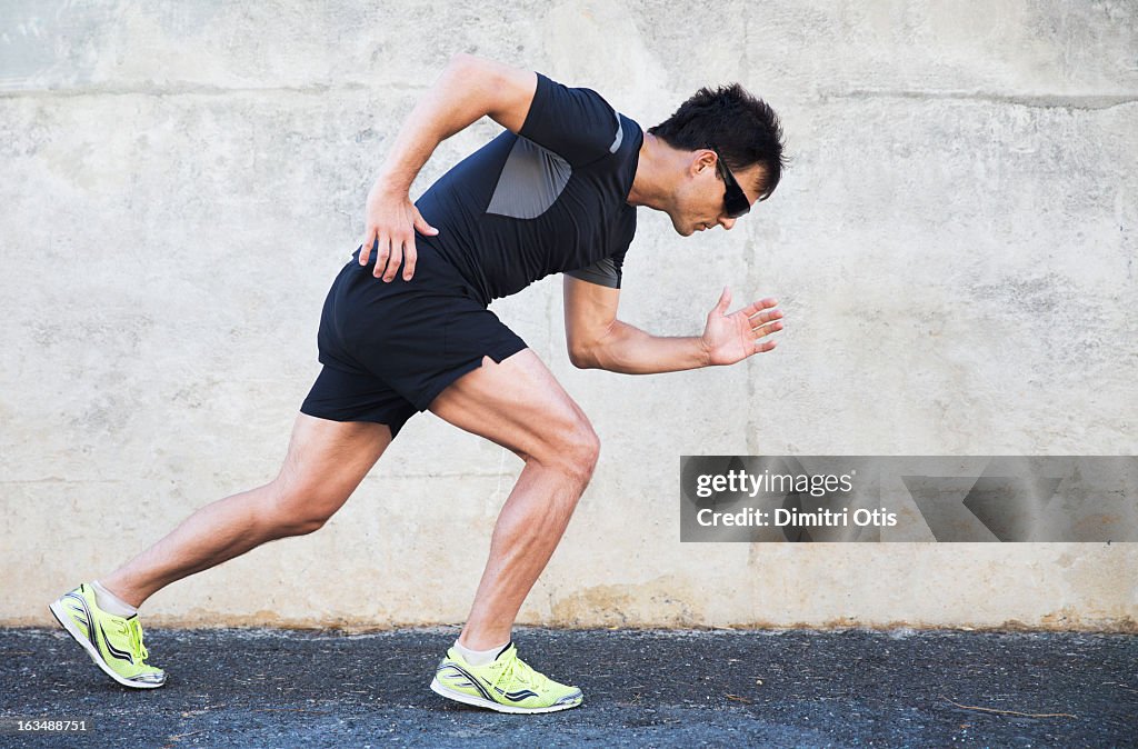 Male athlete in starting position to run