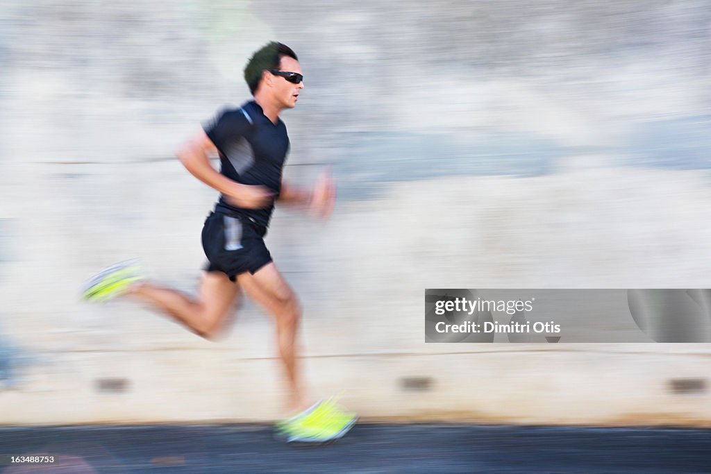 Male athlete running with motion blur