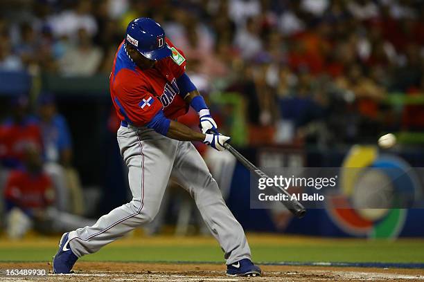 Miguel Tejada of the Dominican Republic gets a hit against Puerto Rico during the first round of the World Baseball Classic at Hiram Bithorn Stadium...