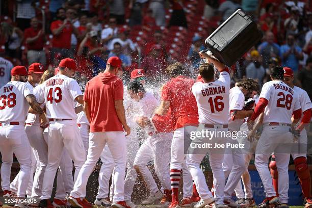 Tommy Edman of the St. Louis Cardinals is doused with water after hitting a walk-off two-run home run against the San Diego Padres in the ninth...