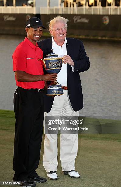 Developer Donald Trump poses with Tiger Woods after the final round of the World Golf Championships-Cadillac Championship at the Trump Doral Golf...