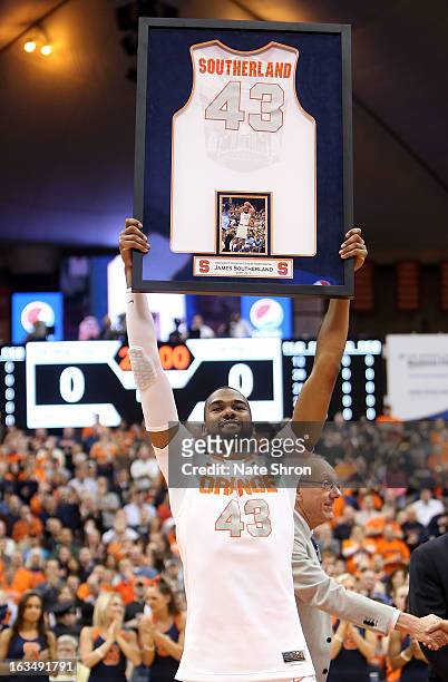 James Southerland of the Syracuse Orange smiles as he holds up his framed jersey during senior night prior to the game against the DePaul Blue Demons...