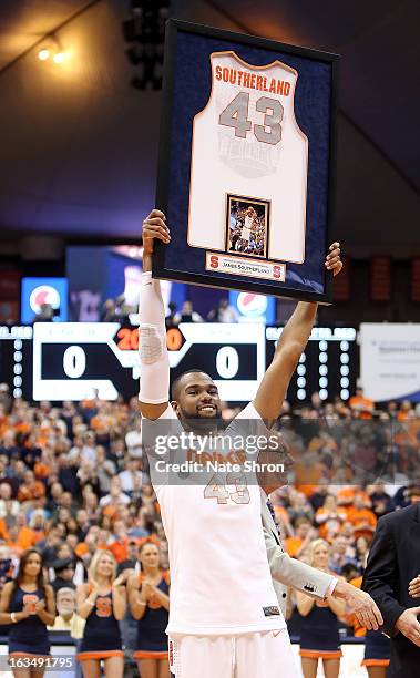 James Southerland of the Syracuse Orange smiles as he holds up his framed jersey during senior night prior to the game against the DePaul Blue Demons...