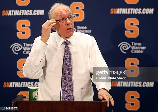 Head coach Jim Boeheim of the Syracuse Orange scratches his head during the post game press conference after the win over the DePaul Blue Demons at...