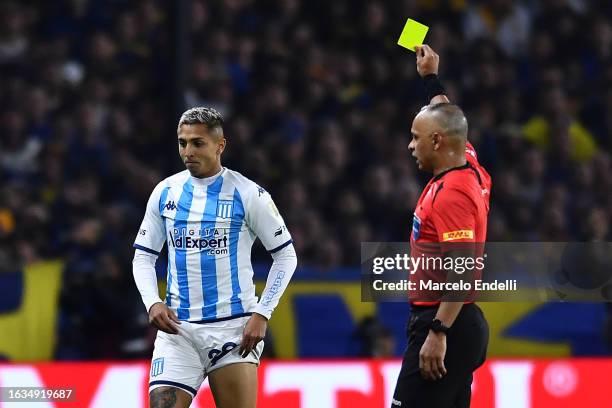 Referee Wilton Sampaio shows a yellow card to Agustín Almendra of Racing Club during the Copa CONMEBOL Libertadores 2023 Quarter-final first leg...